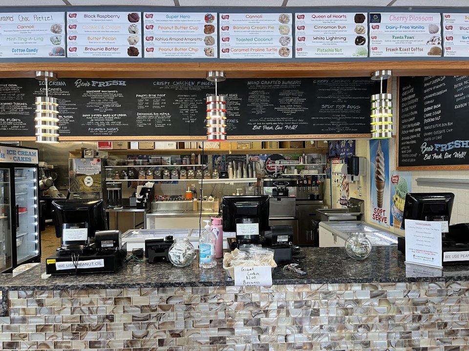 Fresh burgers and fries on a casual restaurant table.
