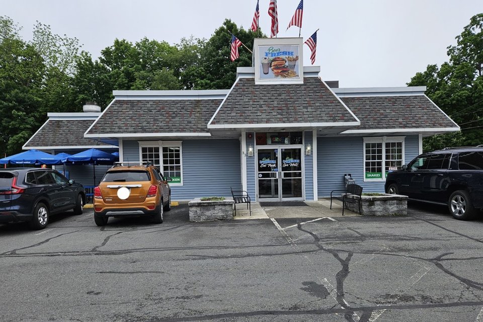Fresh burgers and fries on a casual restaurant table.